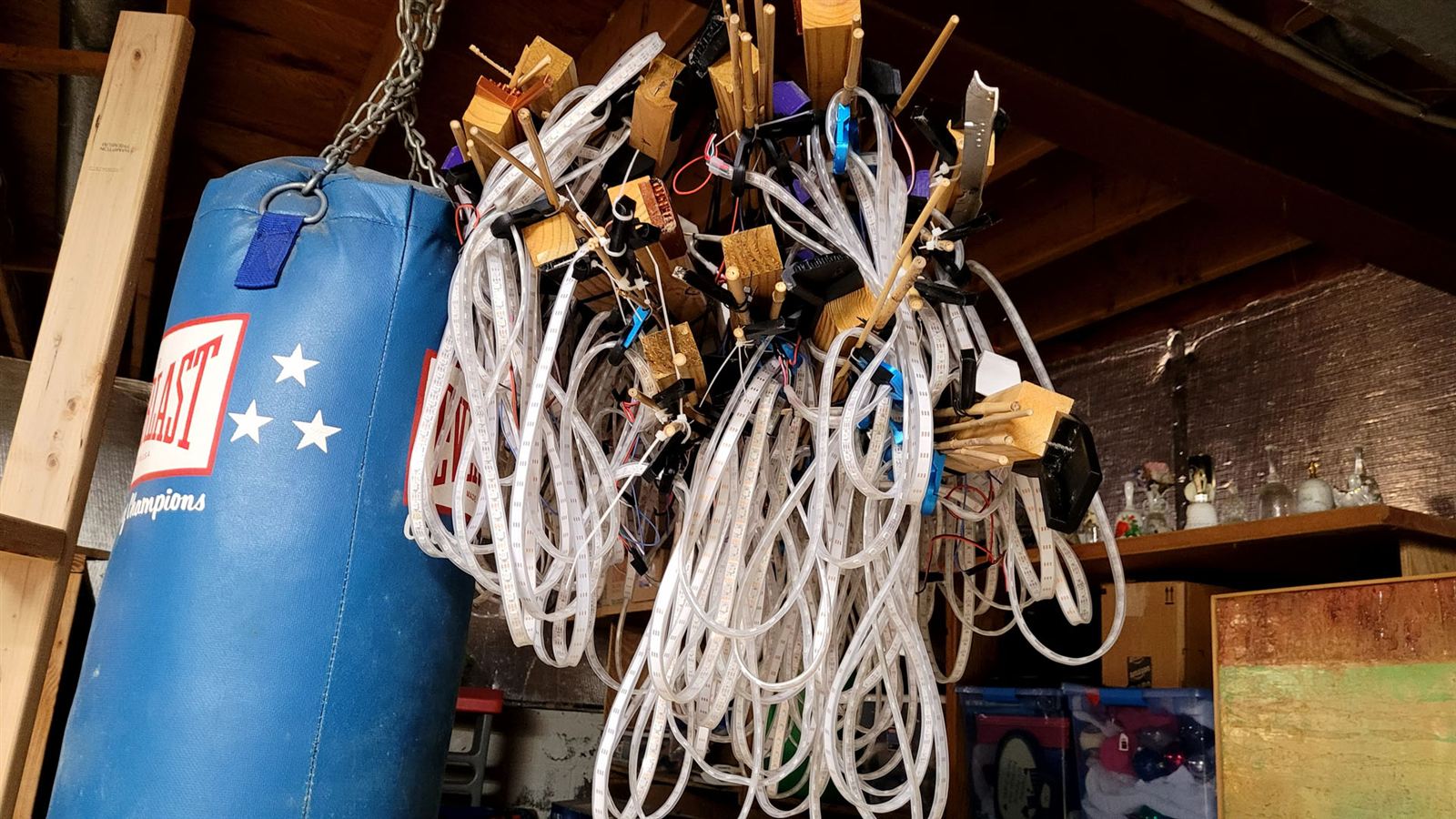 Coils of LED strips, bamboo, and 3D printed parts in storage