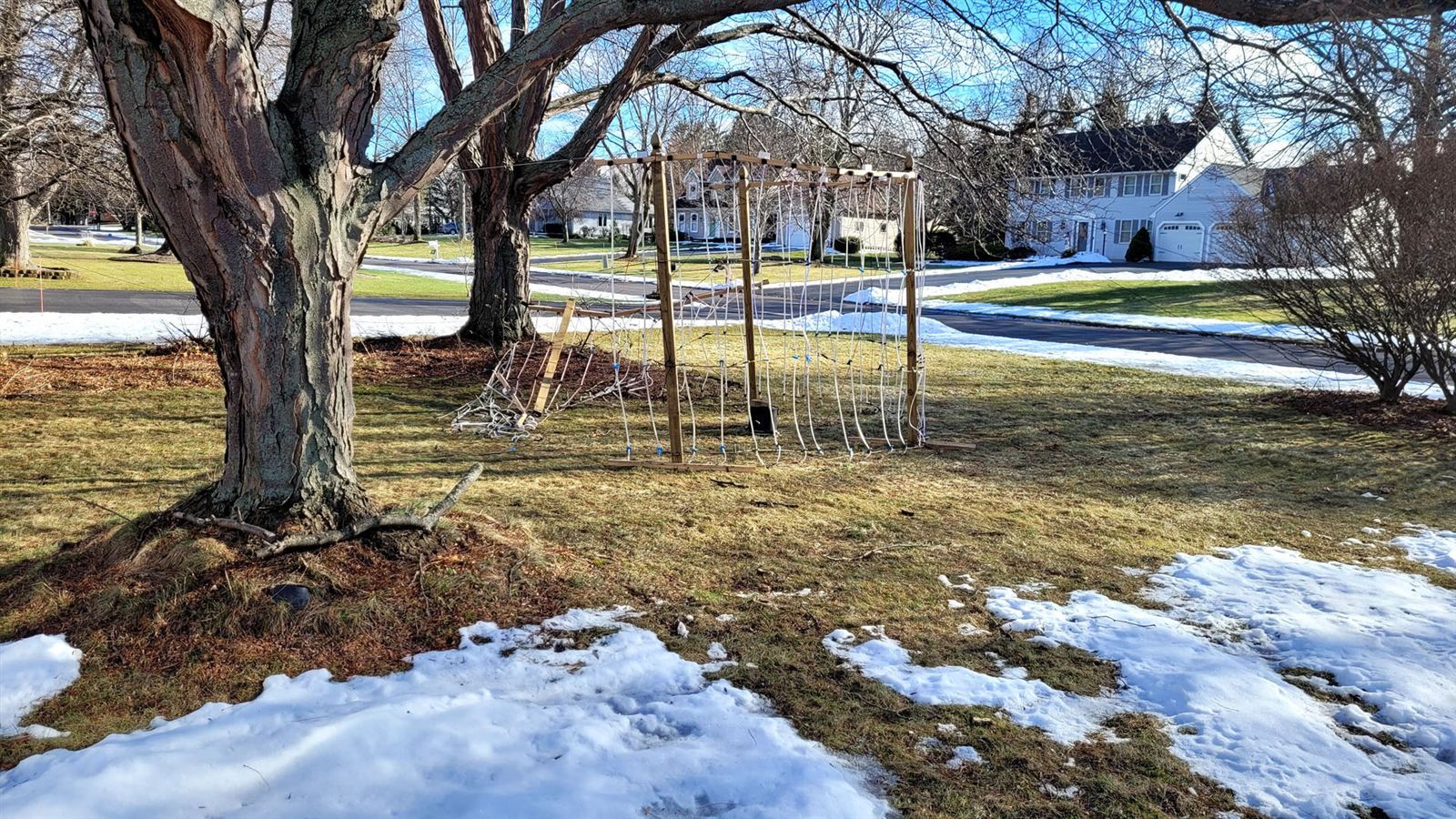 The ring collapsed in the snowy yard after a wind storm
