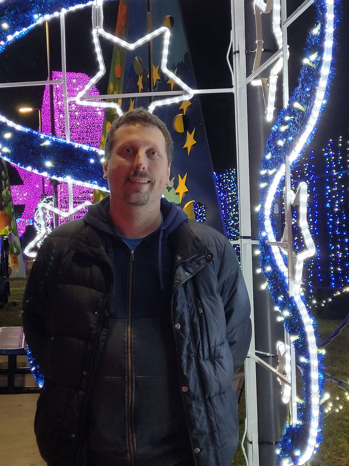 Josh standing among the illuminated displays at the Galaxy of Lights