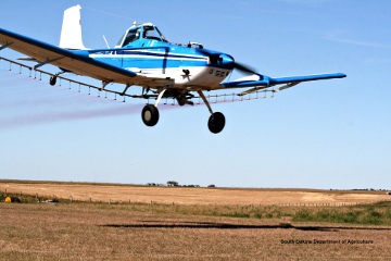Agricultural sprayer working a field